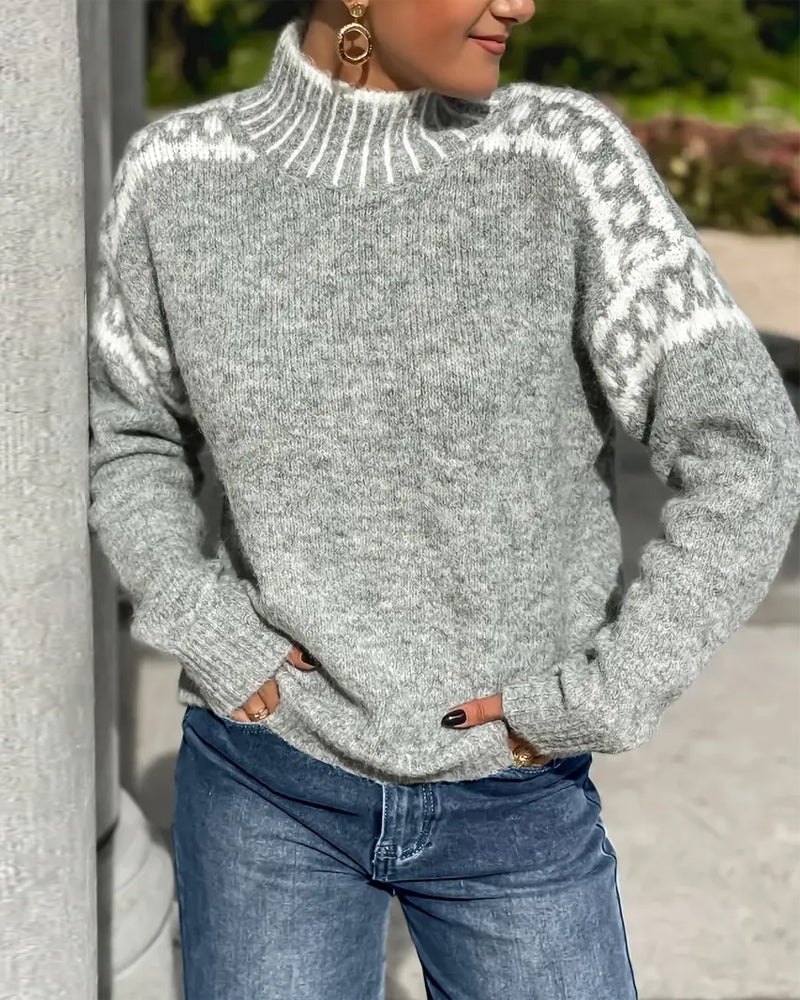Woman in a grey Nordic-pattern mock neck sweater, an après-ski outfit idea